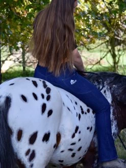 Bootleg Denim Riding Jeans With Phone Pockets, Choose Your Length And Silicone Option -Famous Saddlery Shop Horse riding jeans with bootleg back view on horse f2500680 559b 450c 8b94 dc241e9dfc30